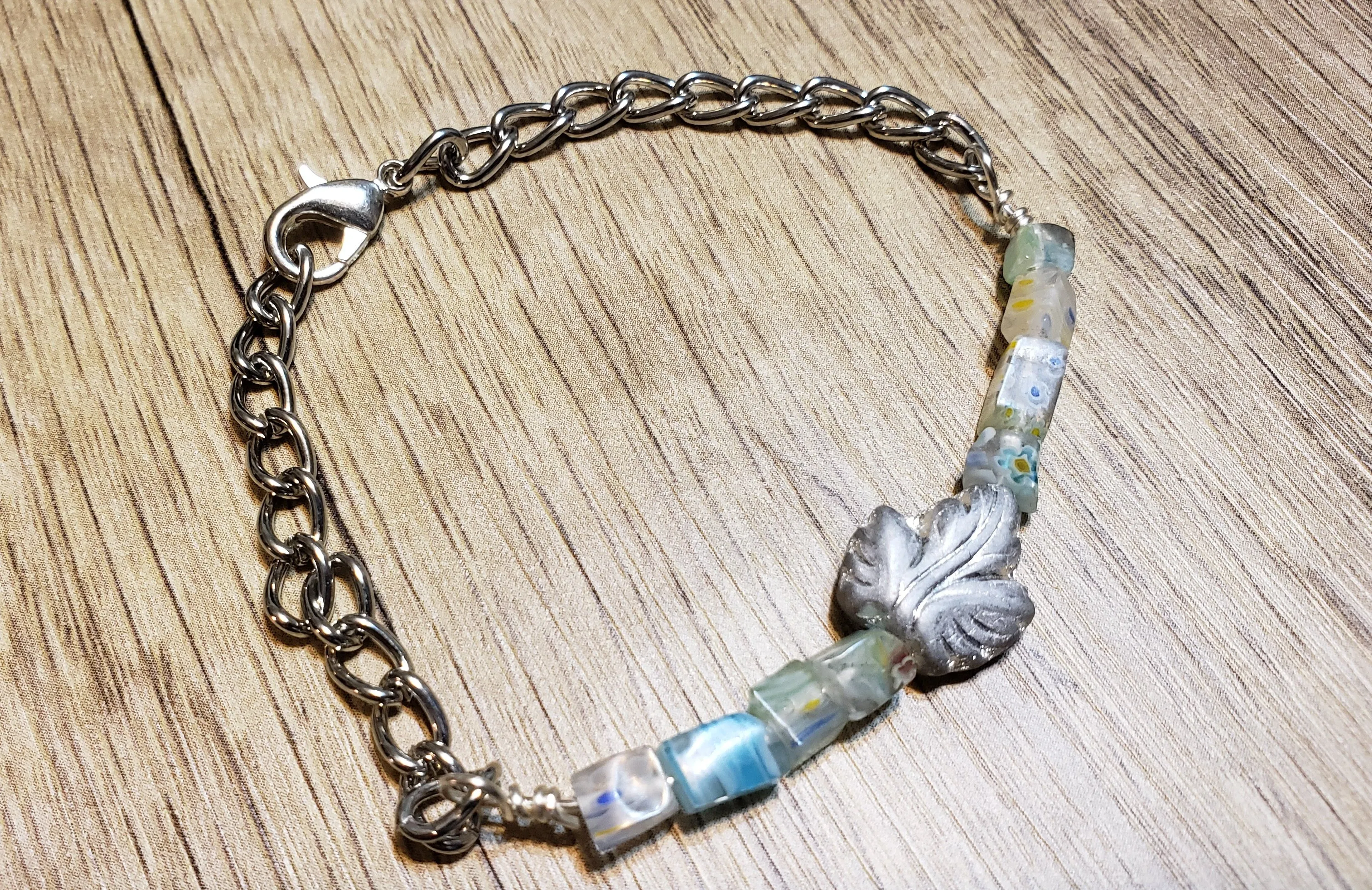 Hand Crafted Light Blue Millefiori Glass with Leaf Accent & Silver Chain Bracelet. Adjustable to 8.5" with Lobster Claw Clasp