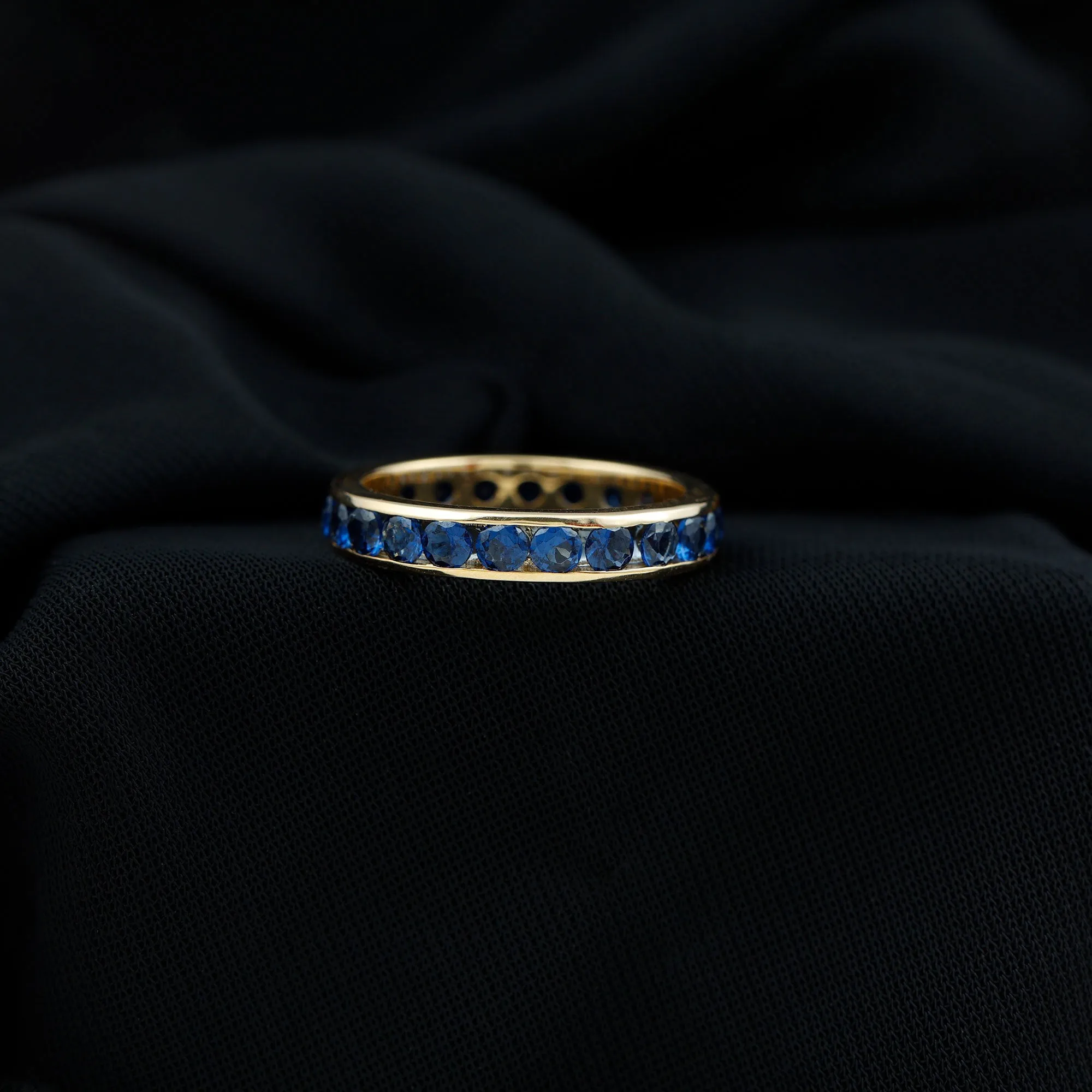 Round Created Blue Sapphire Full Eternity Ring in Channel Setting