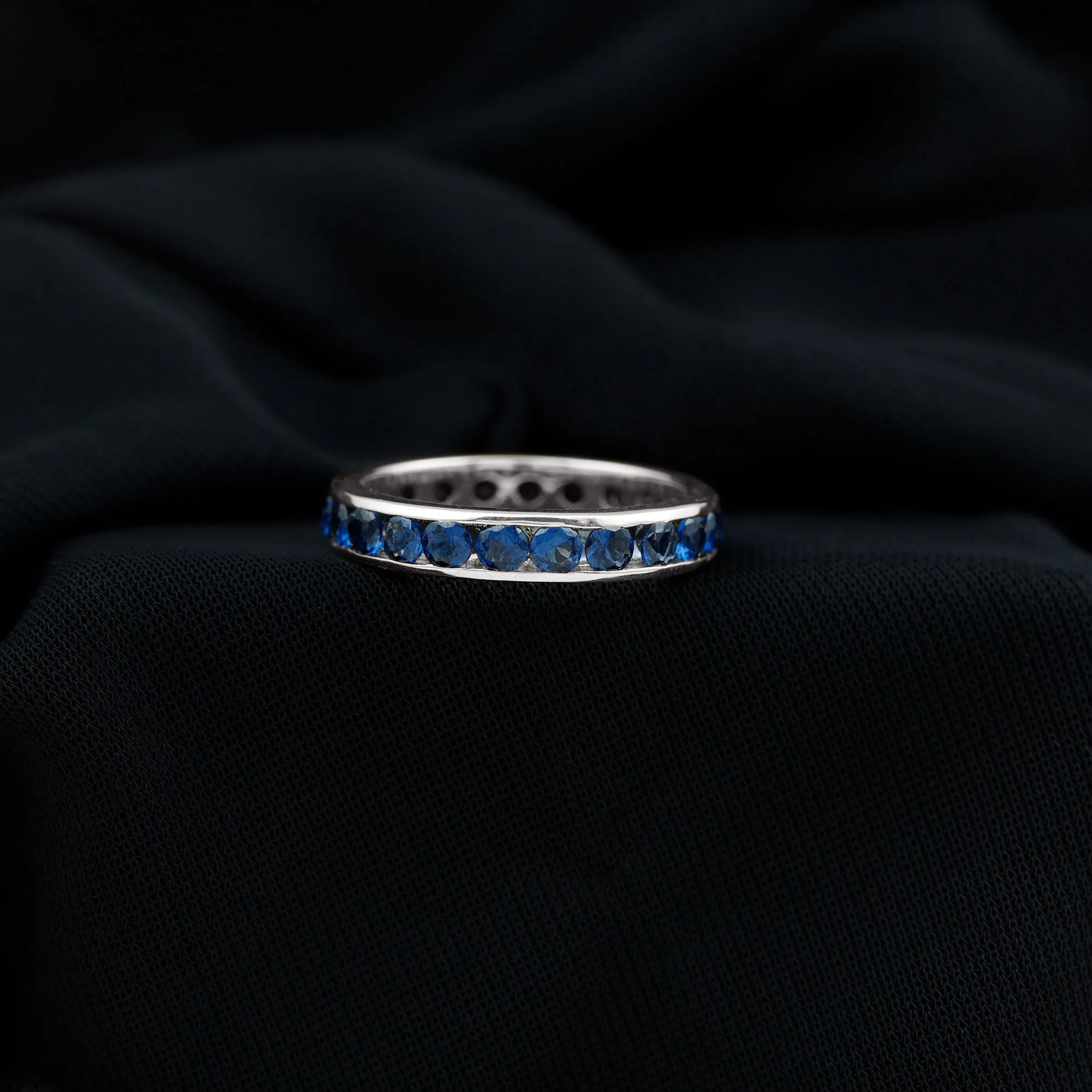 Round Created Blue Sapphire Full Eternity Ring in Channel Setting